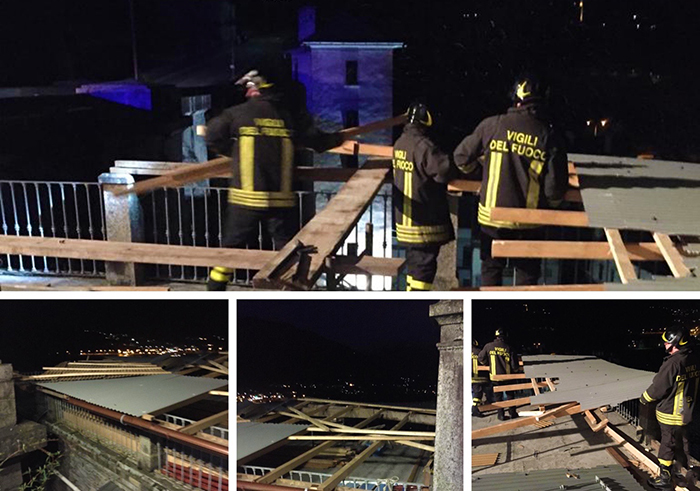 Assi e lamiere di una tettoia sradicate dal vento. Vigili del fuoco in azione