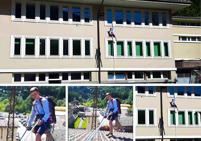 Studente si cala dal tetto della scuola per l'esame, a osservarlo preside e professori. Foto